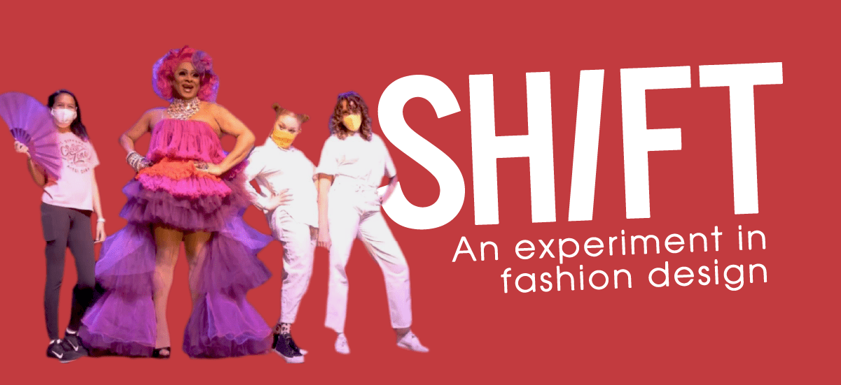 SHIFT - An experiment in fashion design. Image: Featuring runway participants: a drag performer wearing a flowy, colorful dress, surrounded by young students wearing white shirts, white and black pants, while wearing masks.